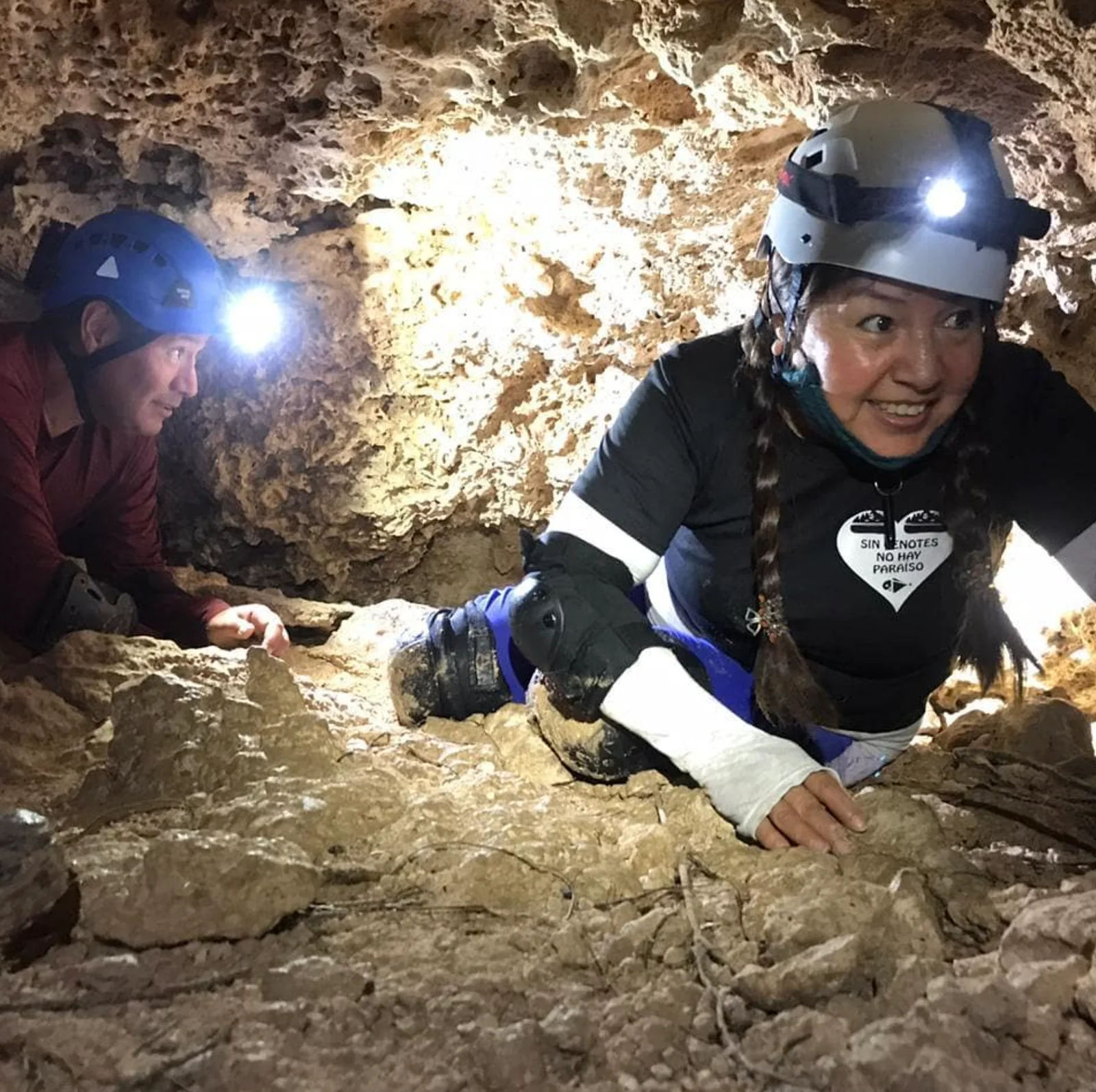 Mis papás explorando juntos el interior de una cueva, con cascos y lámparas